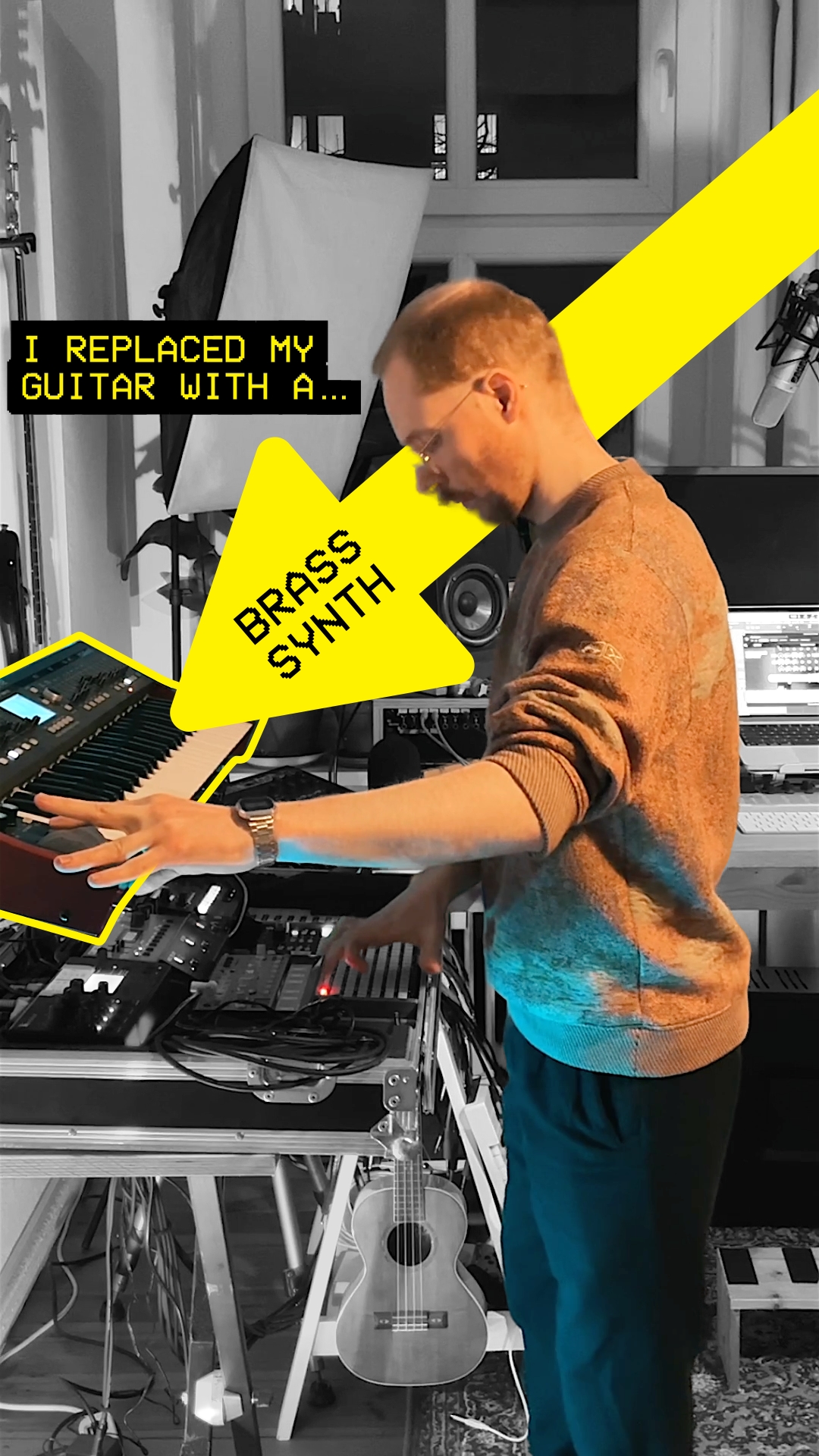 Mxmx standing in front of his brass-synth with one hand on the modwheel.