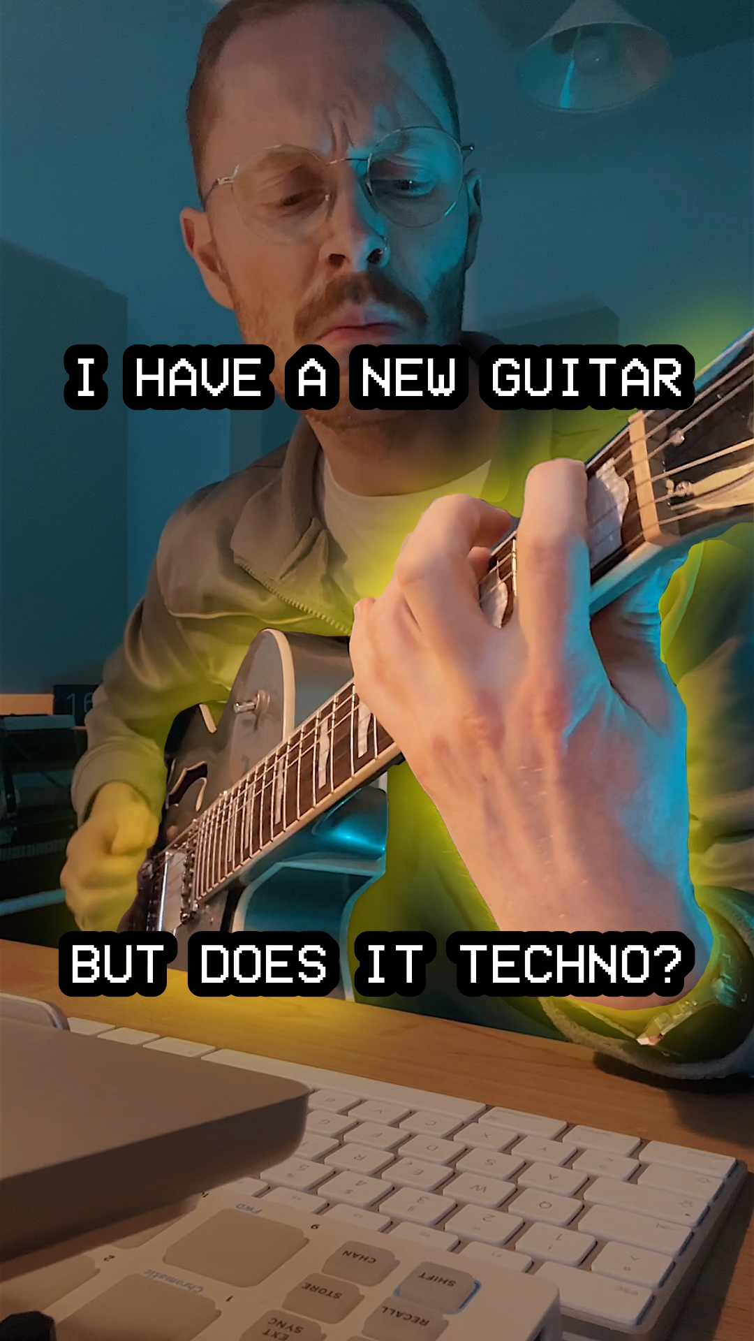 Guy playing his new guitar. The guitar has a divine halo.