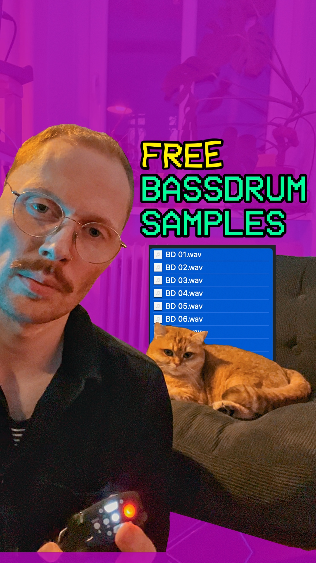 A guy looking at the camera like a serious person. In the background a cat is sitting on an armchair looking cute.