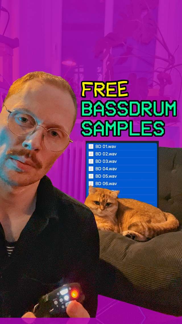 A guy looking at the camera like a serious person. In the background a cat is sitting on an armchair looking cute.